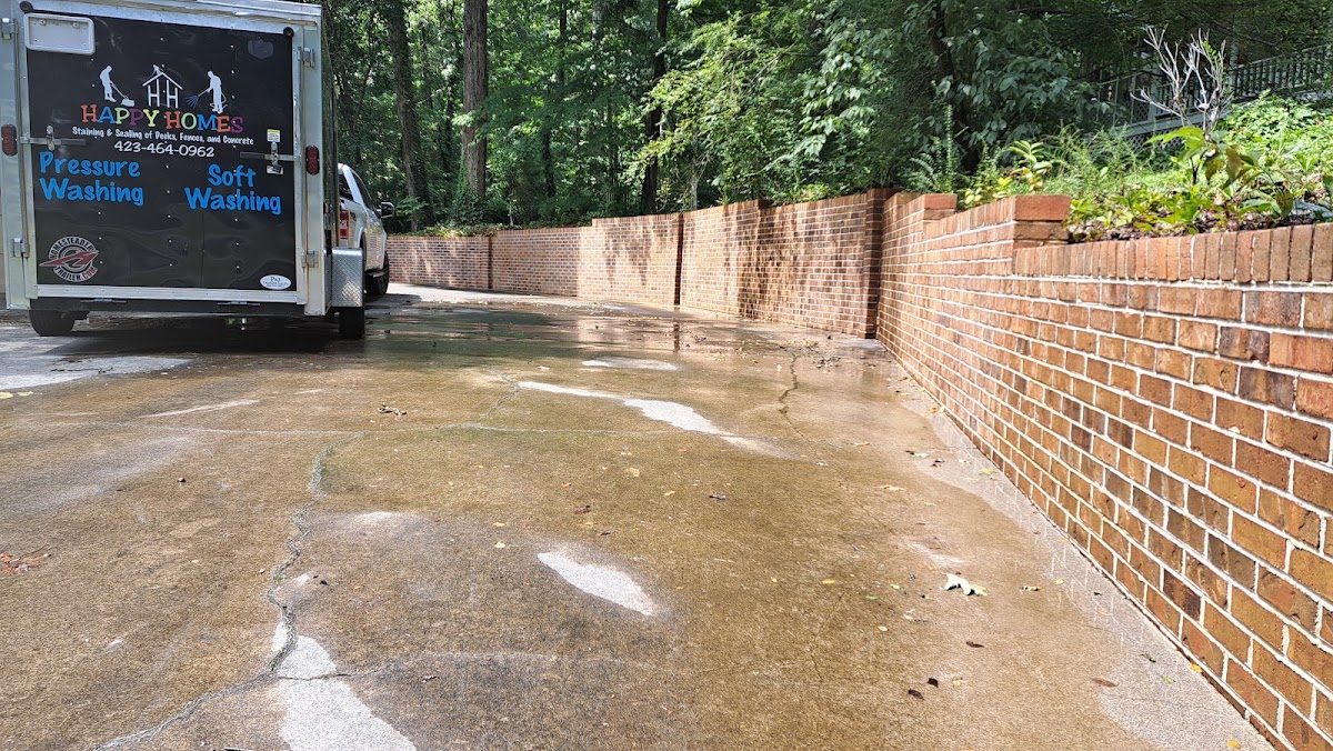 Freshly washed concrete along a brick garden wall